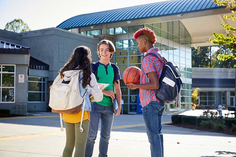 students talking outside of school